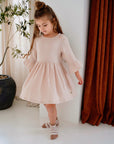 girl wearing cream pink organic cotton muslin dress