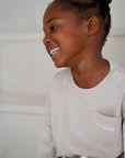 child wearing beige cotton slub long sleeve t-shirt close up