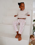 child wearing light lavender cotton slub long sleeve t-shirt with striped pants