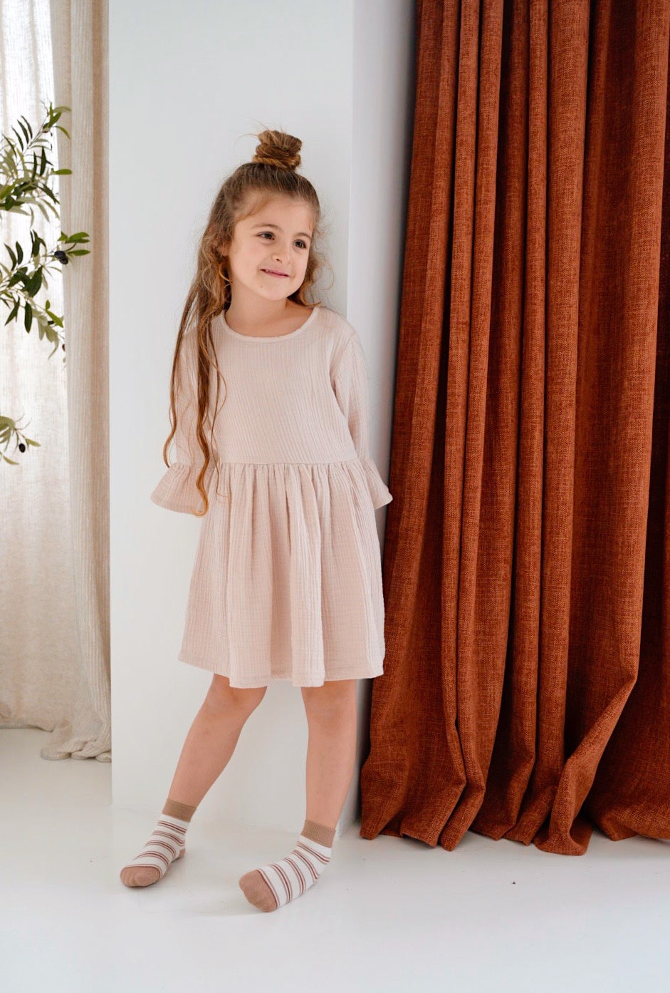 girl wearing cream pink organic cotton muslin dress