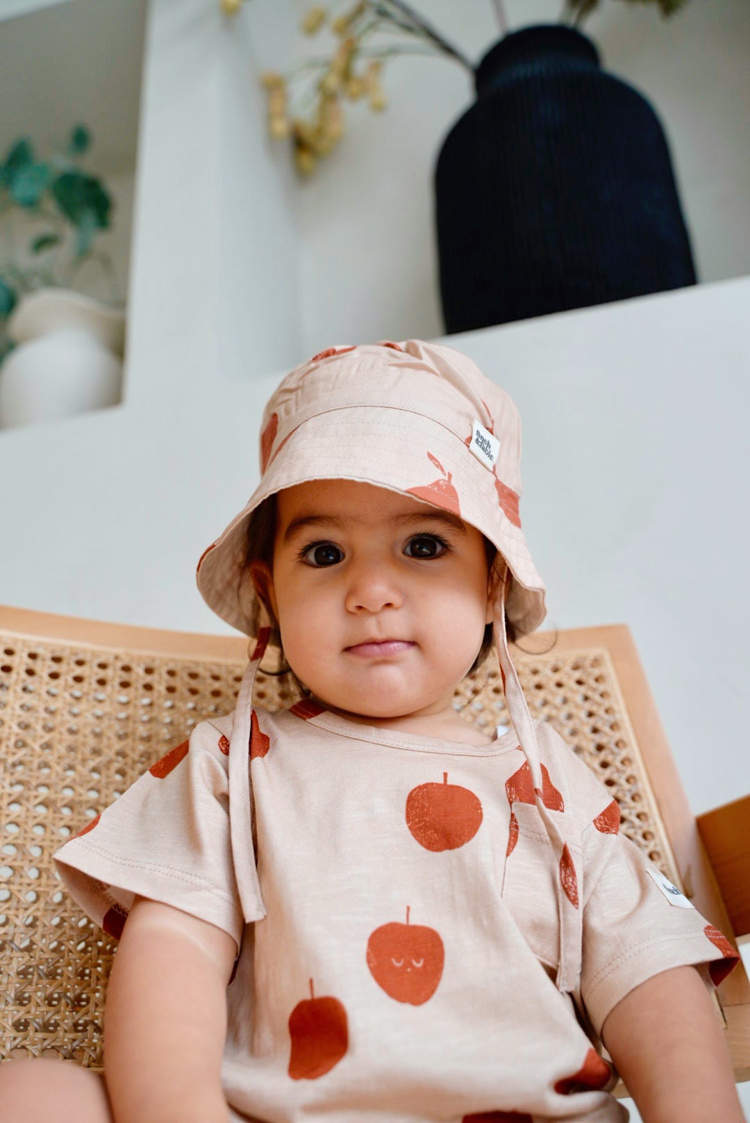 Child wearing beige slub short sleeve t-shirt with fruit print and front pocket front view