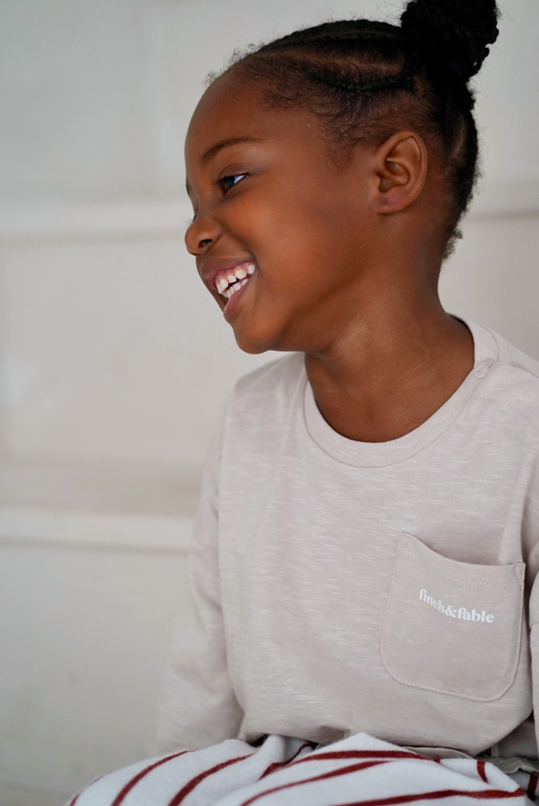 child wearing beige cotton slub long sleeve t-shirt close up