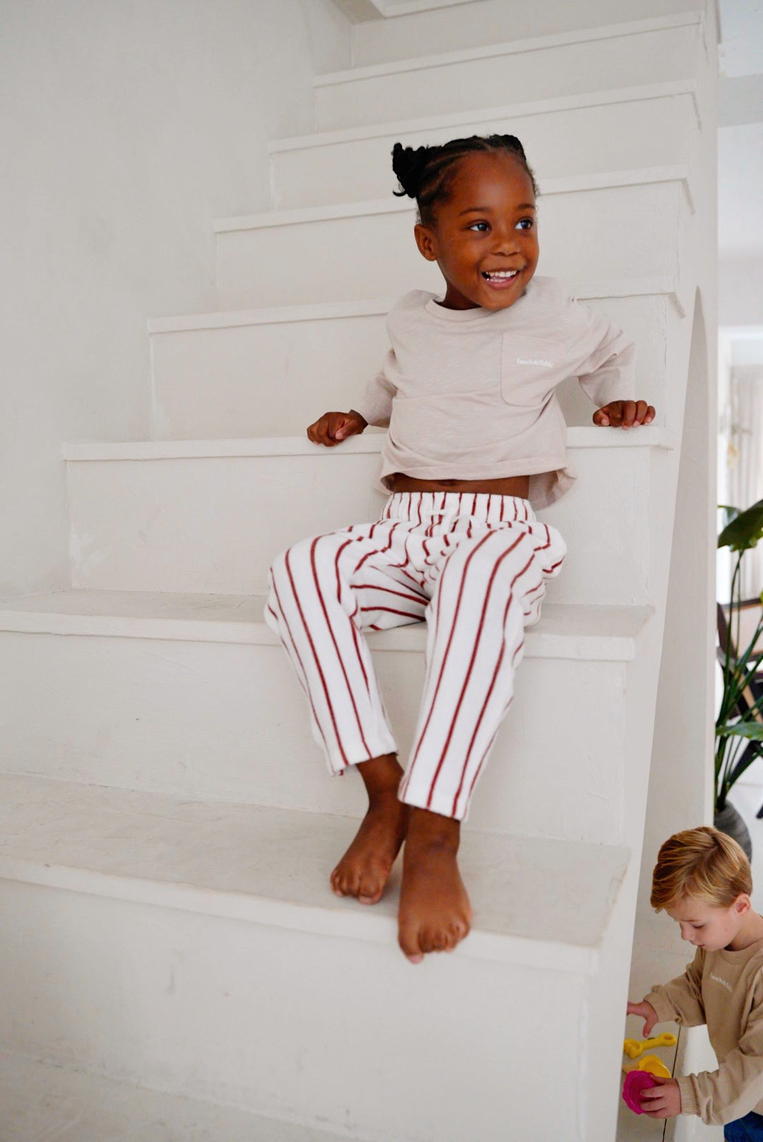 child wearing light lavender cotton slub long sleeve t-shirt with striped pants